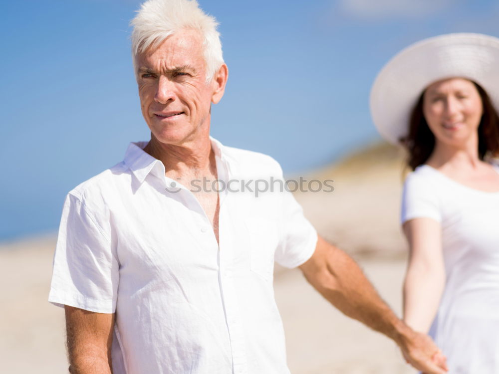 Similar – Senior man and woman having a run along the shore. Scene with sea, sand and trees. Healthy and active way of life