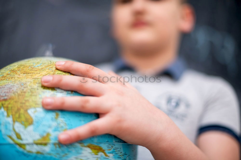 Similar – Image, Stock Photo Schoolgirl covering face with globe