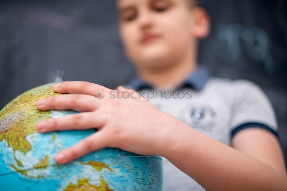 Similar – Image, Stock Photo Schoolgirl covering face with globe