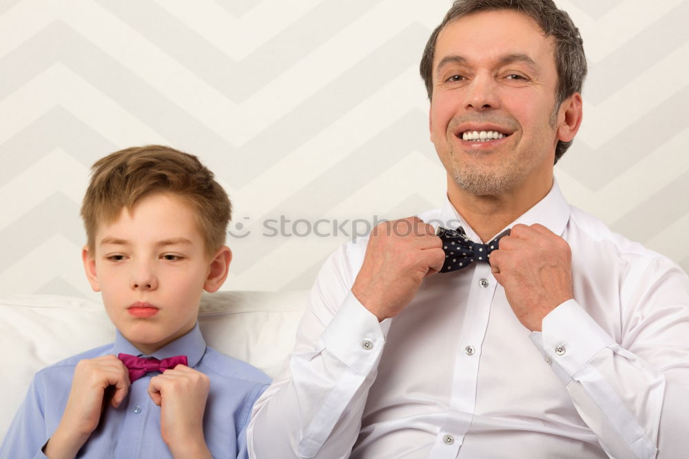 Similar – Image, Stock Photo Father helping son to adjust a bowtie. Preparation before important event