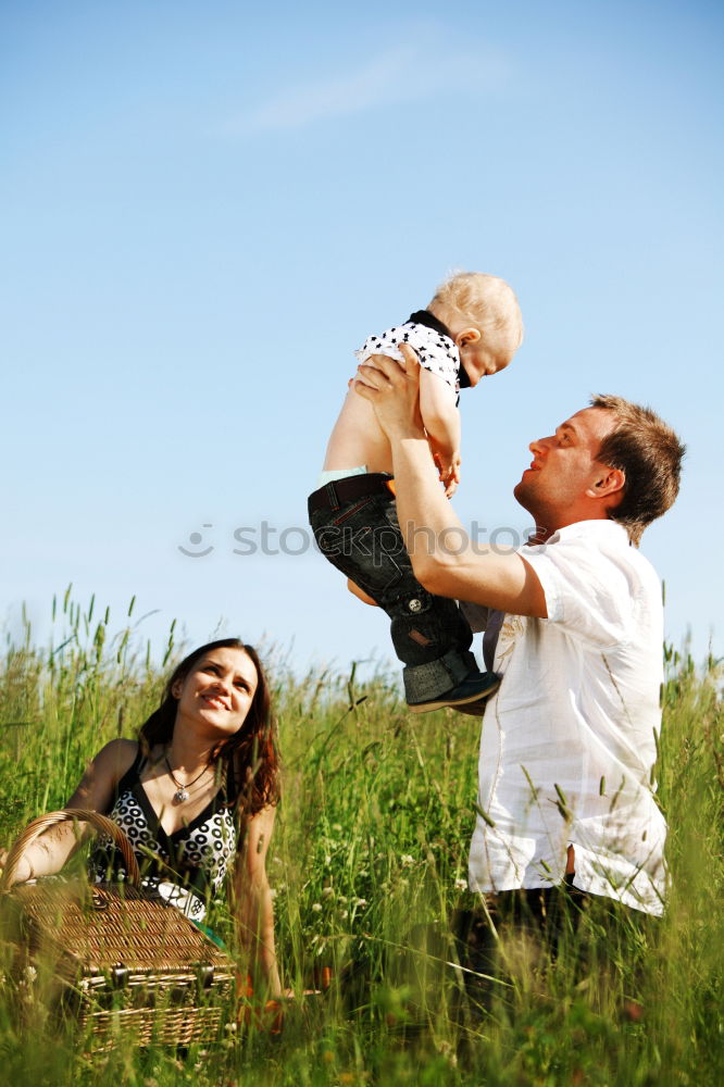 Similar – happy family of four hand in hand on the field