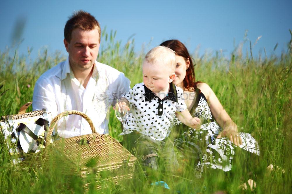 Similar – Image, Stock Photo Baby girl playing with hat of senior man over a nature background