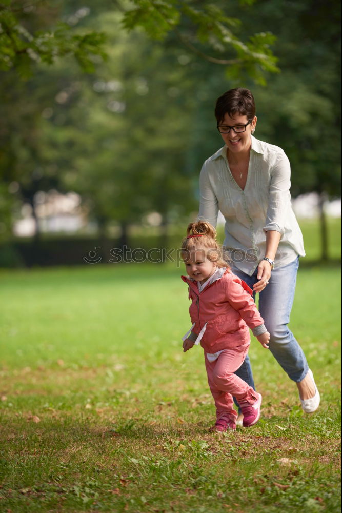 Similar – Mom reading a book her little daughter