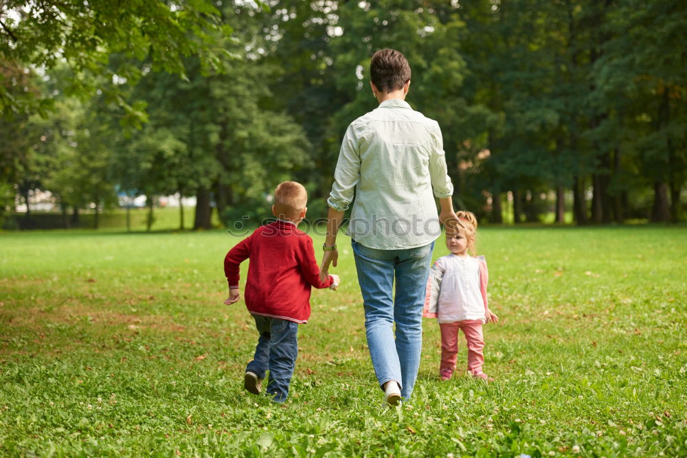 Similar – Children have fun running in nature