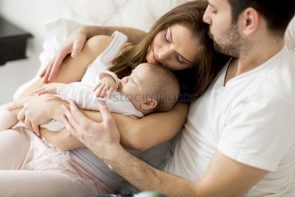 Similar – Image, Stock Photo Newborn lying over bed and couple smiling on background