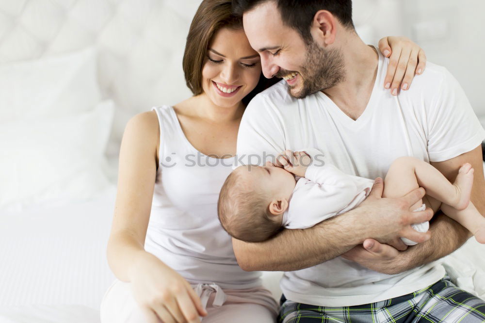 Similar – Image, Stock Photo Couple embracing a newborn over dark background