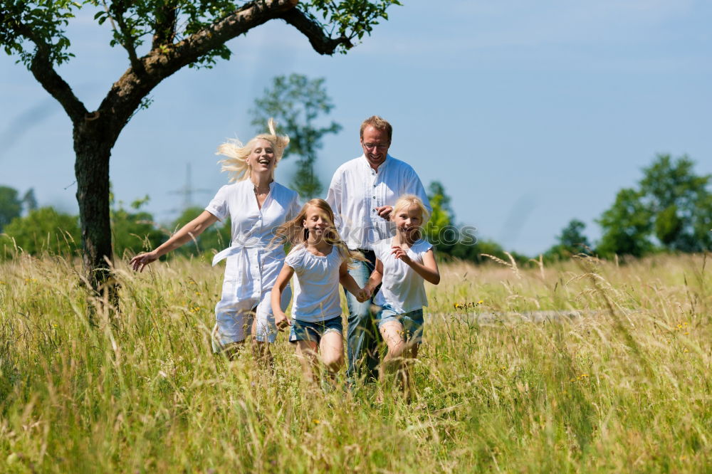 Similar – Grandparents and grandchild jumping on nature path