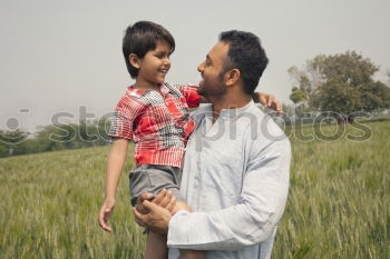 Similar – Image, Stock Photo Father showing grasshopper to children