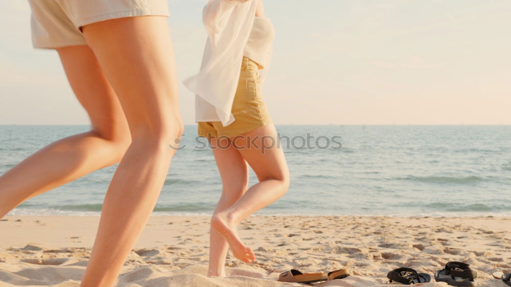 Similar – Group of girls holding surfboard on beach