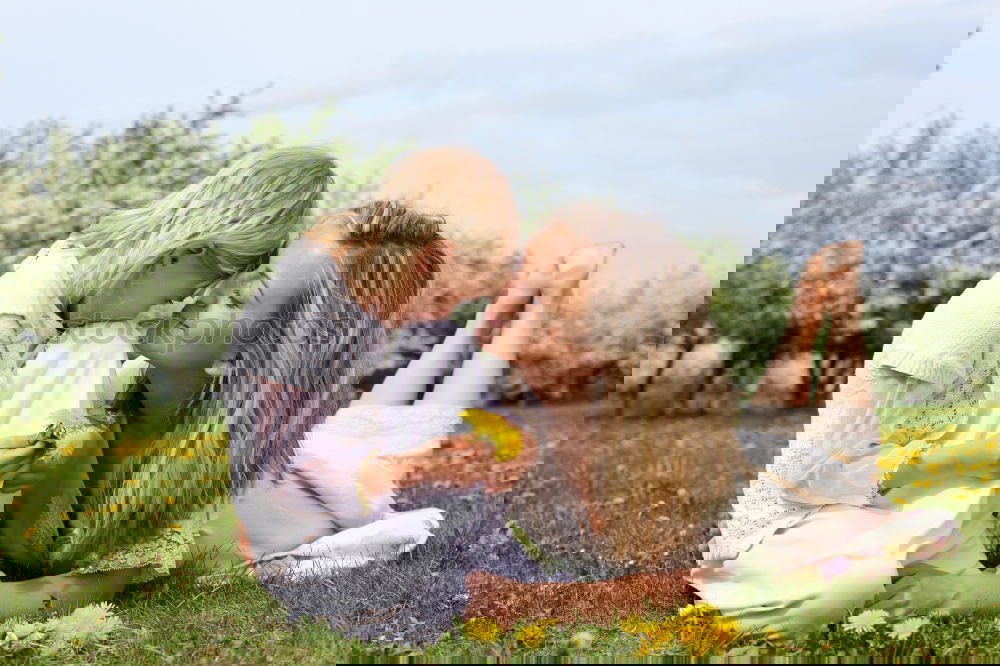 Similar – Image, Stock Photo Young mother forms heart with her children in the high grass