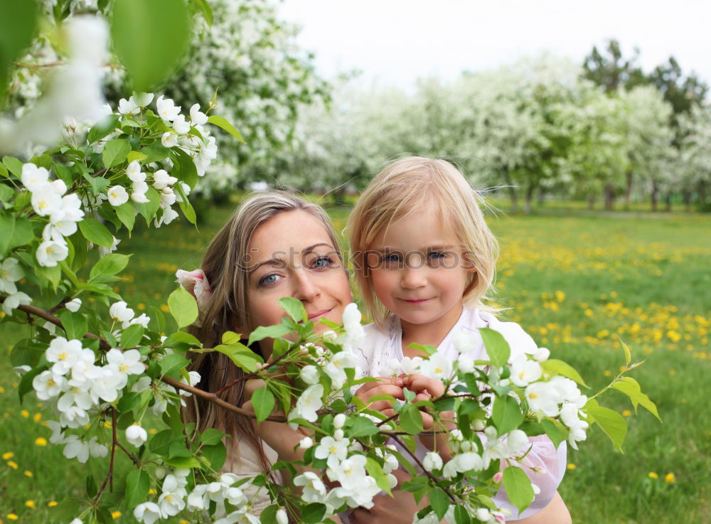 Similar – Image, Stock Photo Little baby is touching fresh spring leaves in her mother’s hug