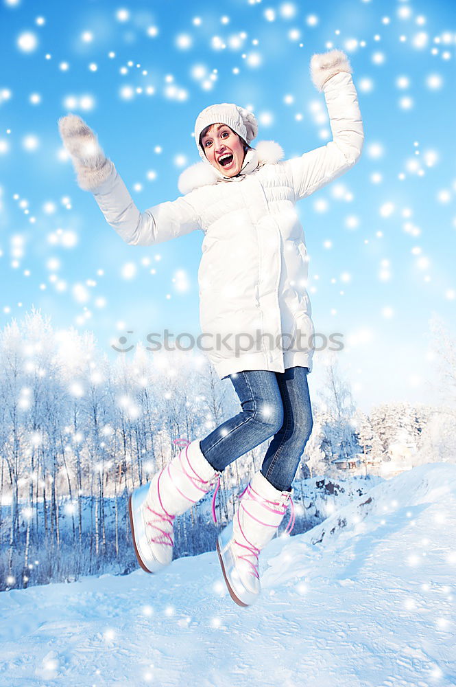 Similar – Mother is playing with her little daughter outdoors on wintery day. Woman is throwing snow on her child. Family spending time together enjoying wintertime. Woman is wearing red coat and wool cap, toddler is wearing dark blue snowsuit