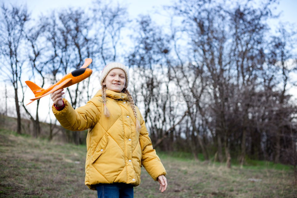 Similar – rothaariger hübscher Teenager, langhaarig mit schwarzer Sonnenbrille, blauer Jacke, orangefarbenem Schirm im Wald