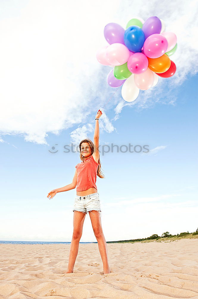 Similar – Father and daughter with balloons playing on the beach