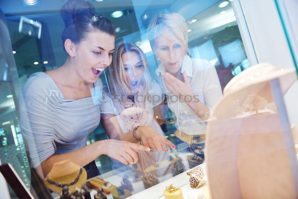 Similar – Attractive young woman paying in a shop