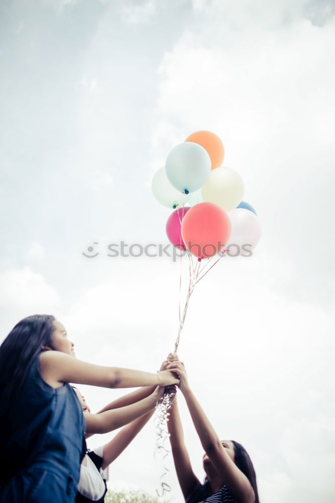 Similar – young woman with balloon on the mountain at a city