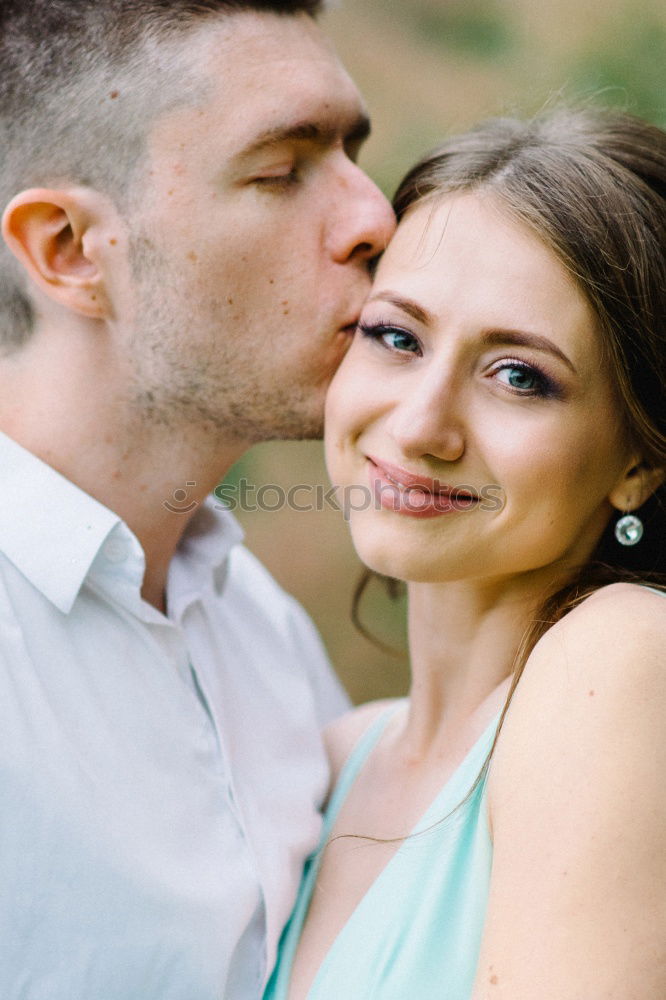 Similar – Image, Stock Photo Young loving couple kissing in the street.