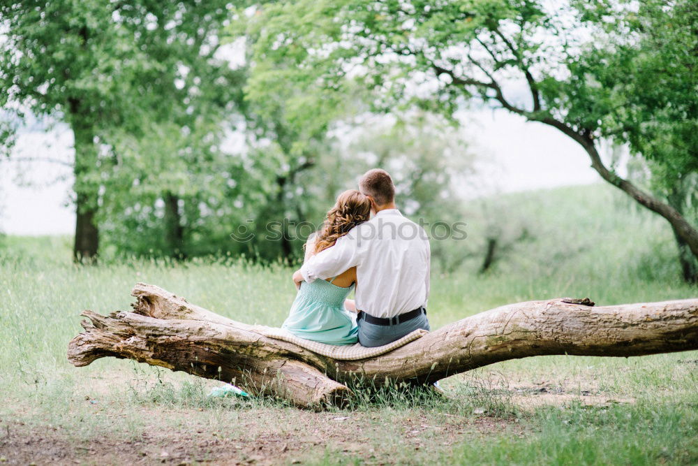 Similar – Couple lying at lake together