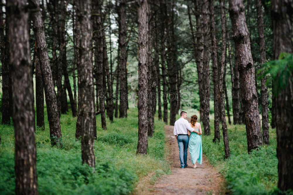 Similar – Retired couple walking their grandson on the path of a forest