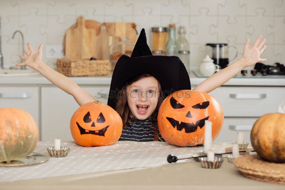 Similar – Image, Stock Photo Happy children disguised decorating a pumpkin at home.