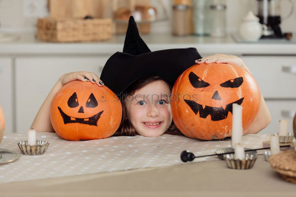 Similar – Image, Stock Photo Happy children disguised decorating a pumpkin at home.