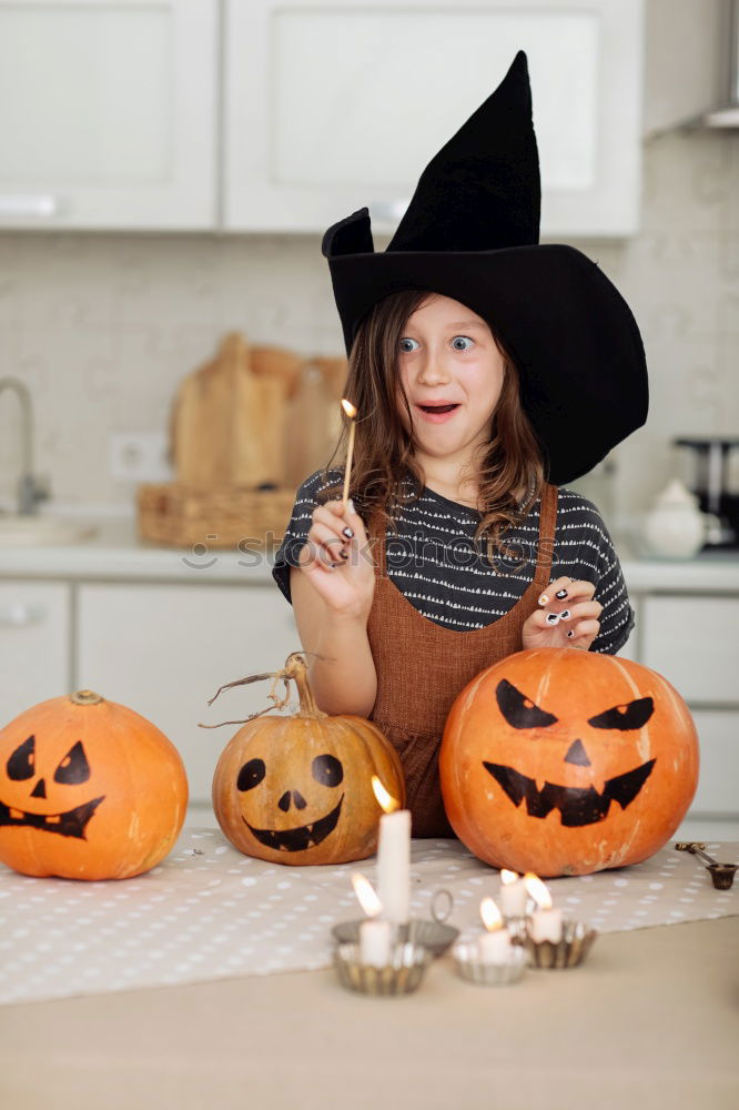 Similar – Image, Stock Photo Happy children disguised decorating a pumpkin at home.