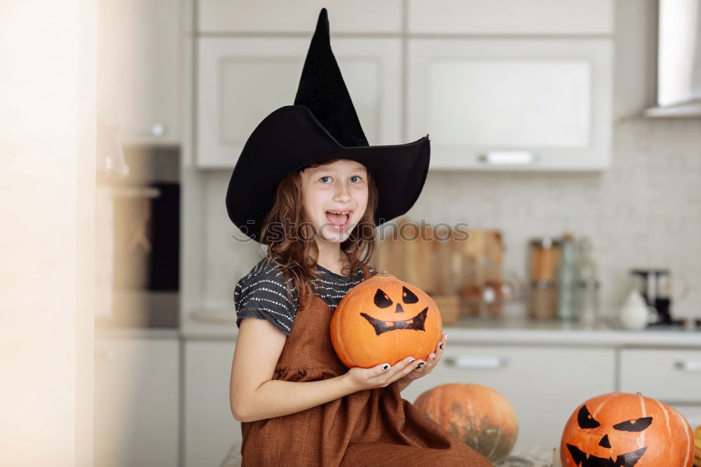 Similar – Image, Stock Photo Beautiful girl disguised of witch decorating a pumpkin at home.