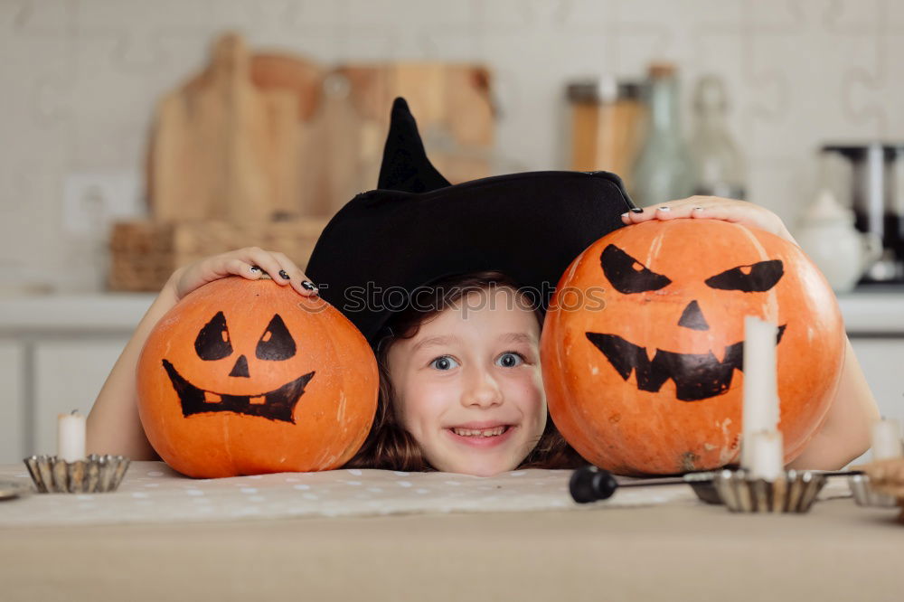 Similar – Image, Stock Photo Happy children disguised decorating a pumpkin at home.