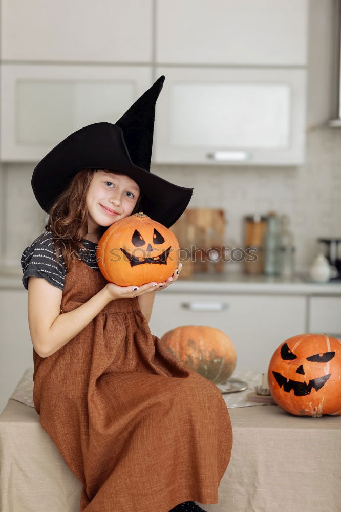 Similar – Image, Stock Photo Happy children disguised decorating a pumpkin at home.