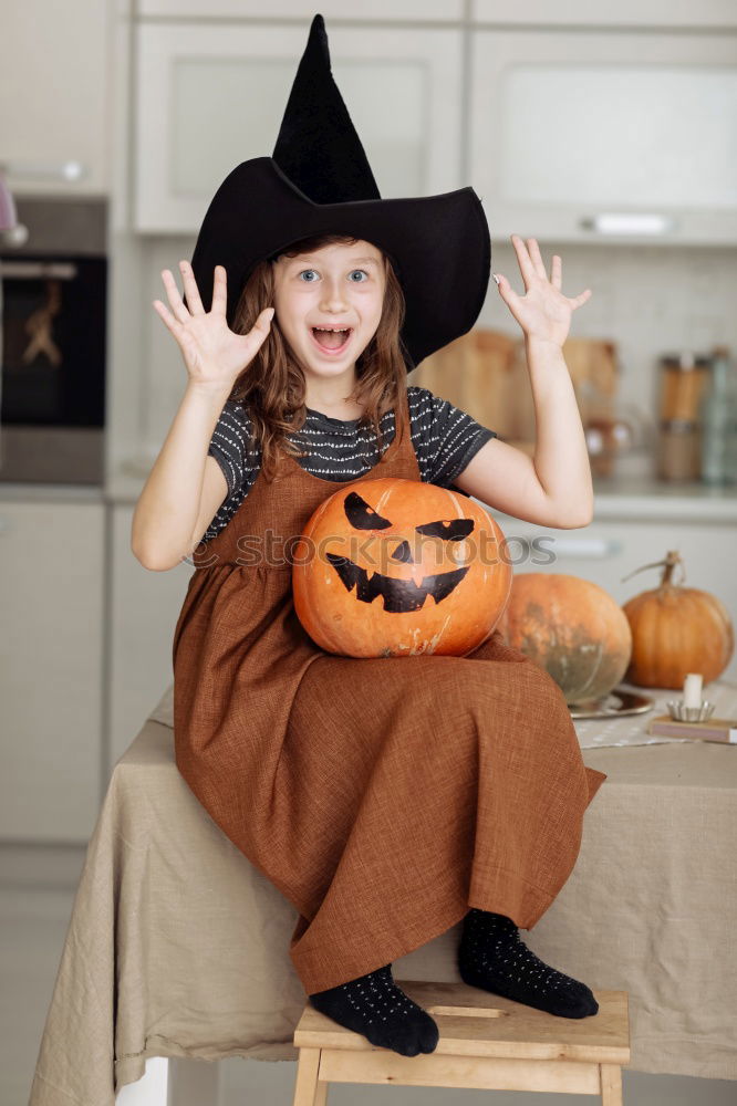 Similar – Image, Stock Photo Happy children disguised decorating a pumpkin at home.