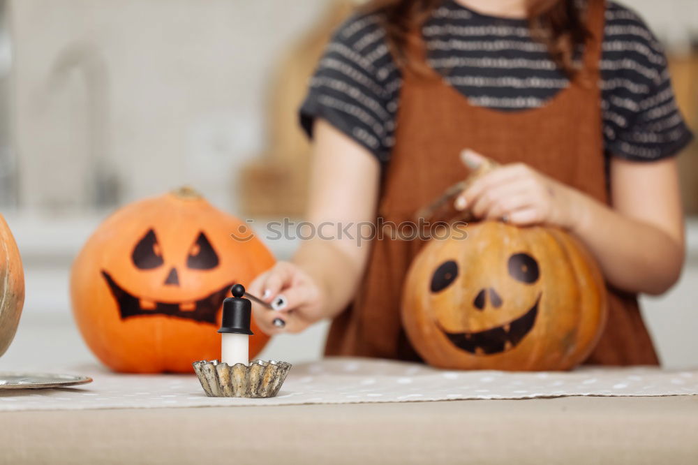 Similar – Image, Stock Photo Happy children disguised decorating a pumpkin at home.