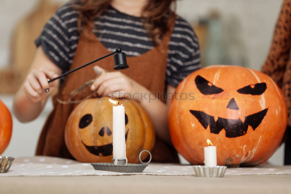 Similar – Image, Stock Photo Happy children disguised decorating a pumpkin at home.