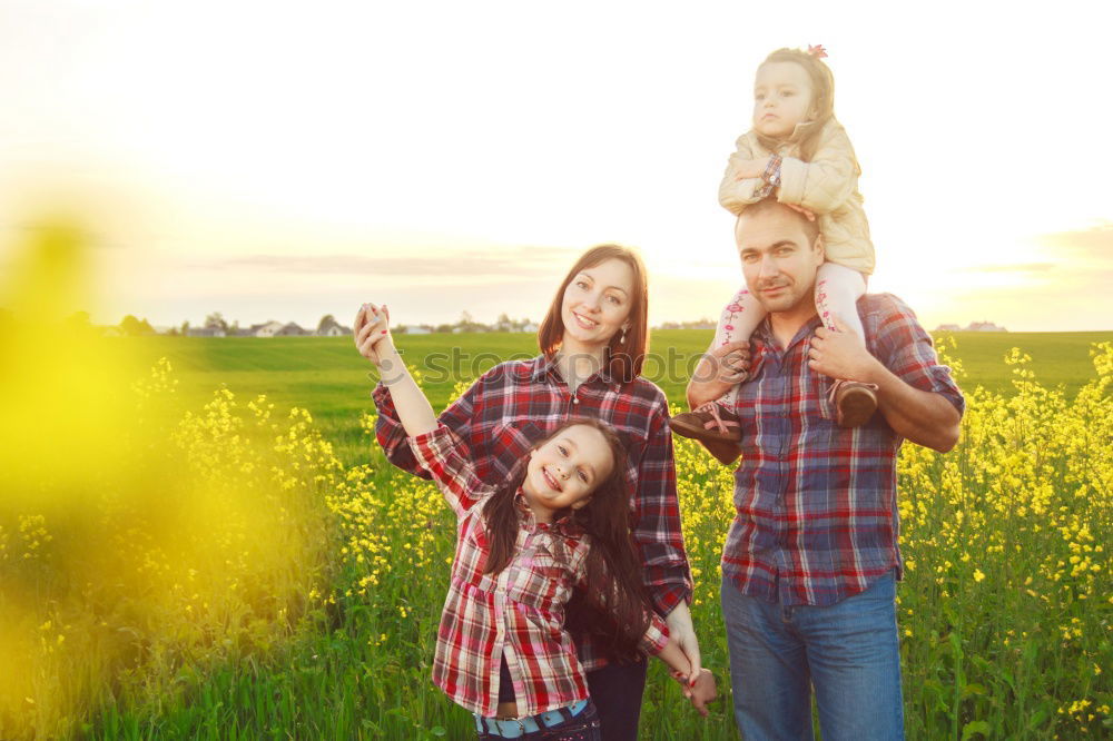 Similar – happy family of four hand in hand on the field