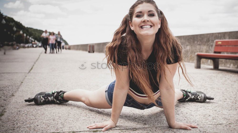 Similar – Happy female riding skate board in street