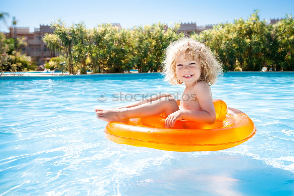 Similar – Two funny kids  in the pool on an air mattress