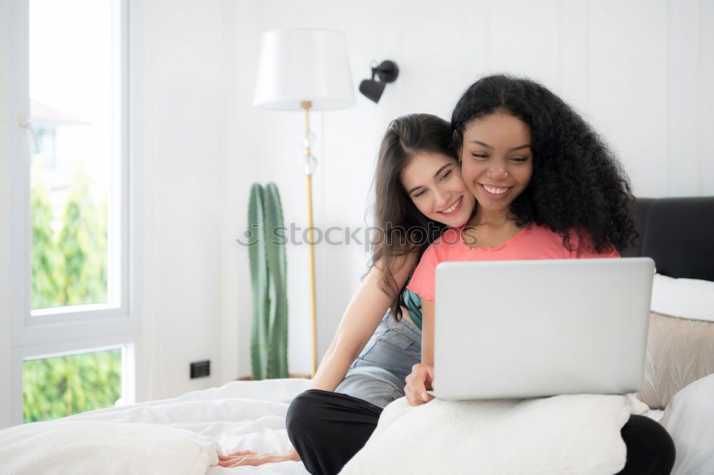 Similar – african happy woman lying on couch with laptop