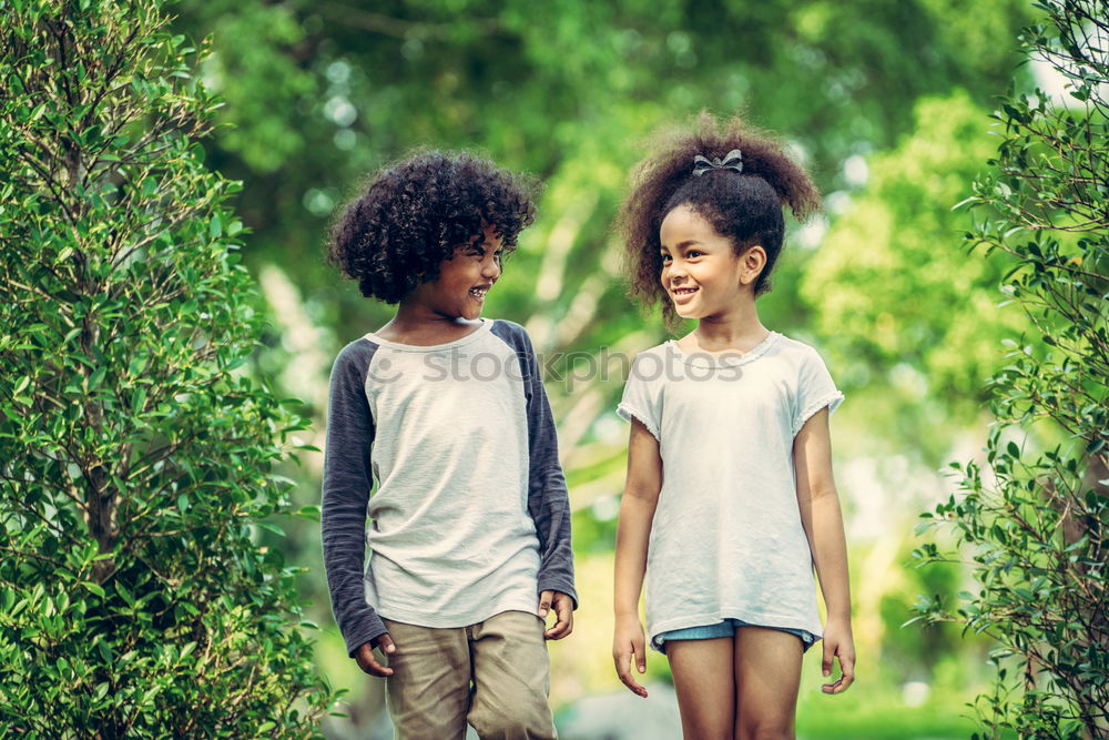 Similar – Two happy children playing near a tree on the grass