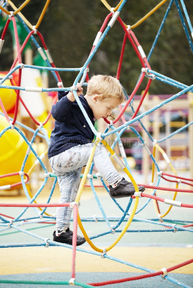 Similar – Child climbing on the playground in autumn