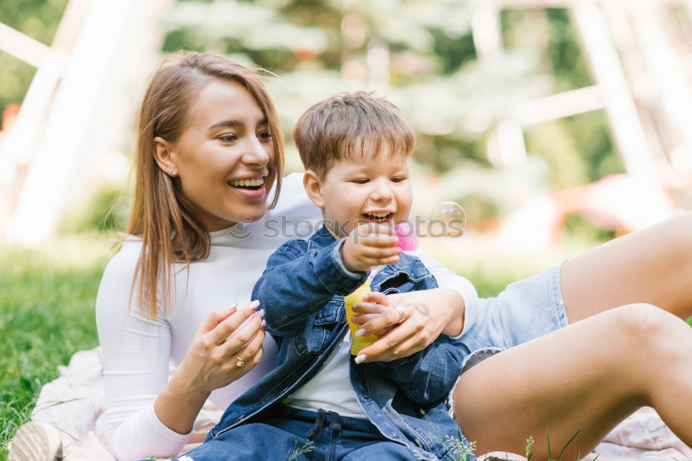 Similar – Image, Stock Photo mother and son playing with soap bubbles in park