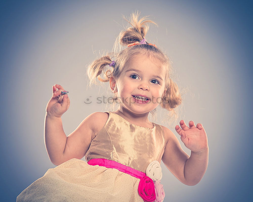 Similar – Image, Stock Photo Little playful, dreamy, pretty, beautiful, sweet, dressed up princess in pink, pink dress with tulle, stands at carnival, carnival as a spectator, visitors at the carnival procession in the street, on confetti and looks, watches, enjoys the party.