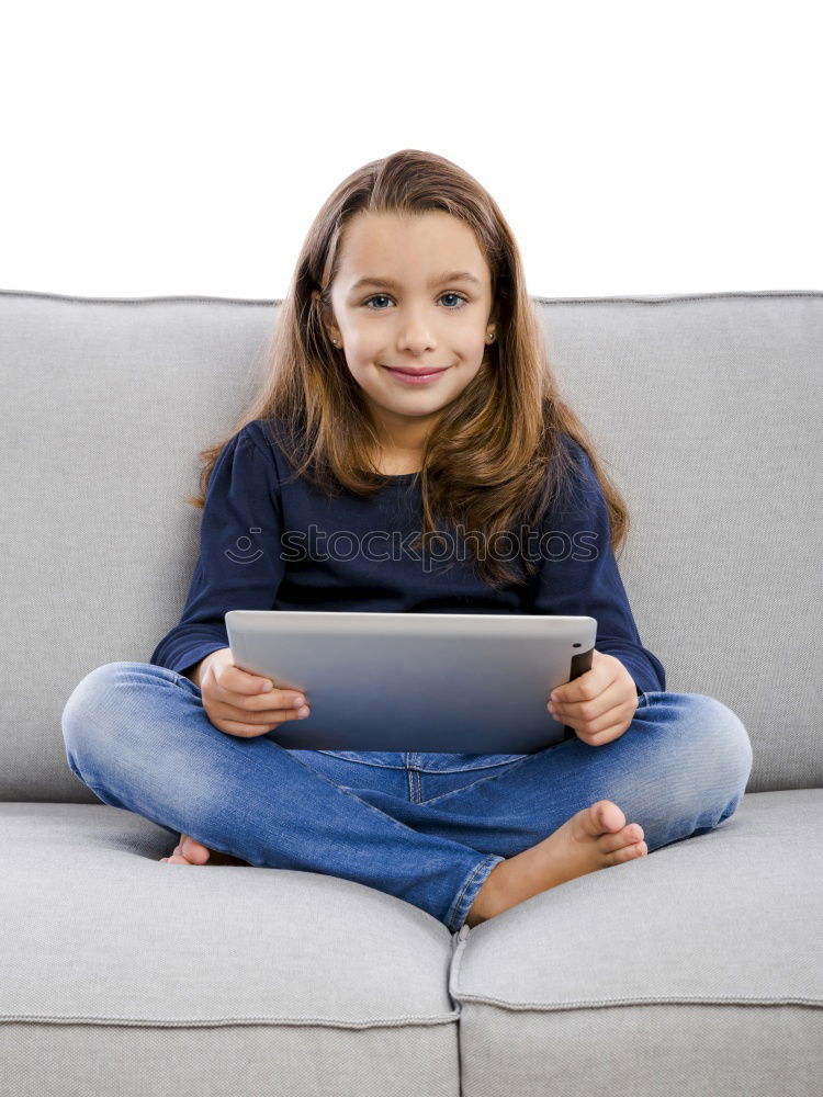 Similar – Little girl using a tablet at home