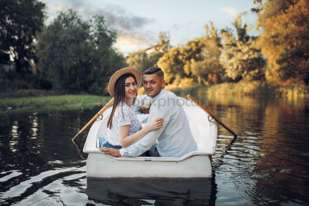 Similar – Couple lying at lake together