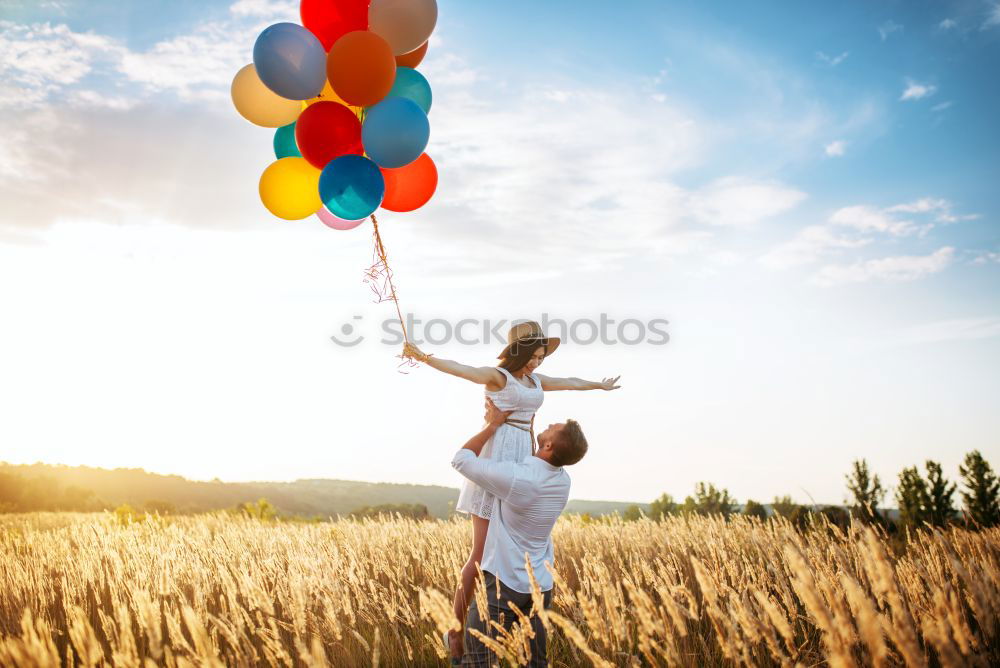 Similar – Father and daughter with balloons playing on the beach