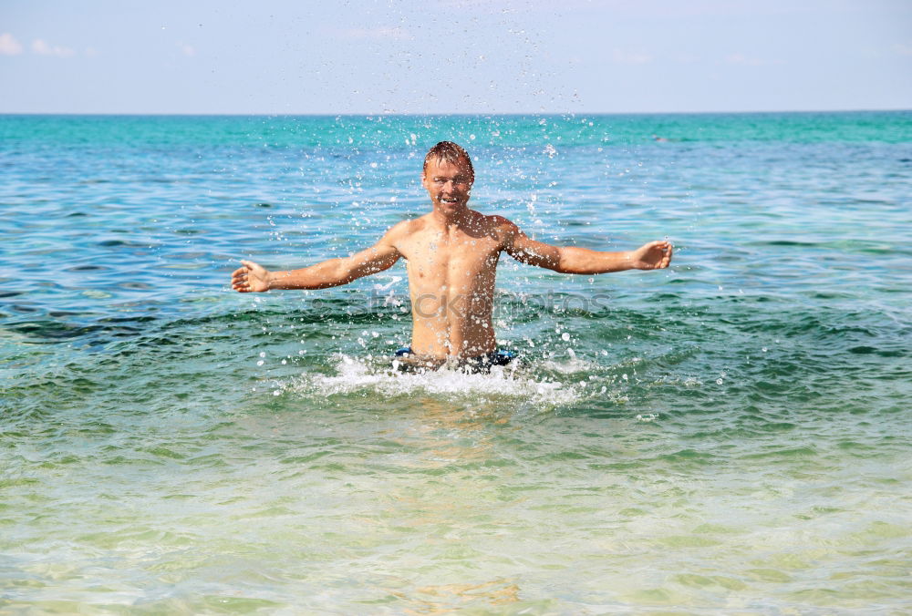 Similar – Little boy floating on the sea with transparent water