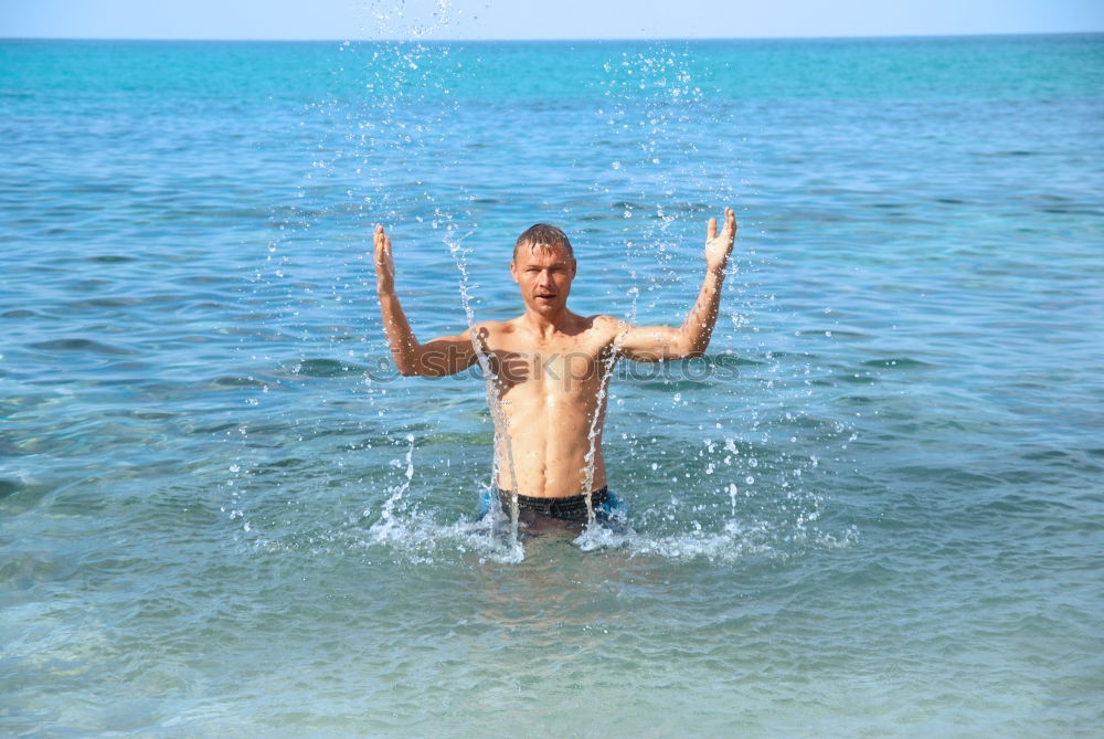 Similar – Little boy floating on the sea with transparent water