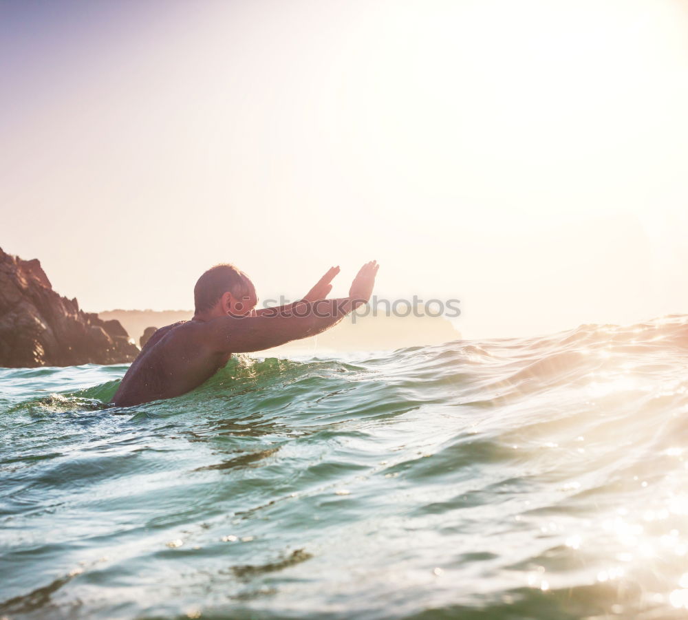 Similar – Image, Stock Photo Man in wetsuit swimming in ocean