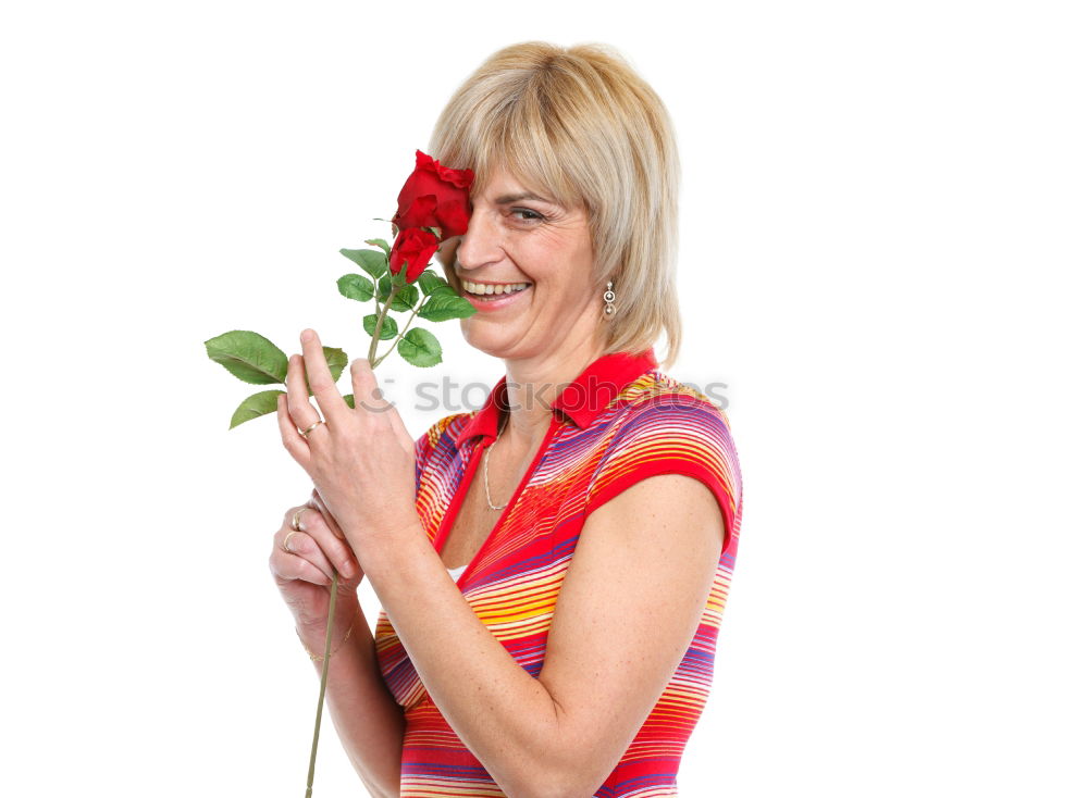 Similar – Redhead woman smelling a flower in a park