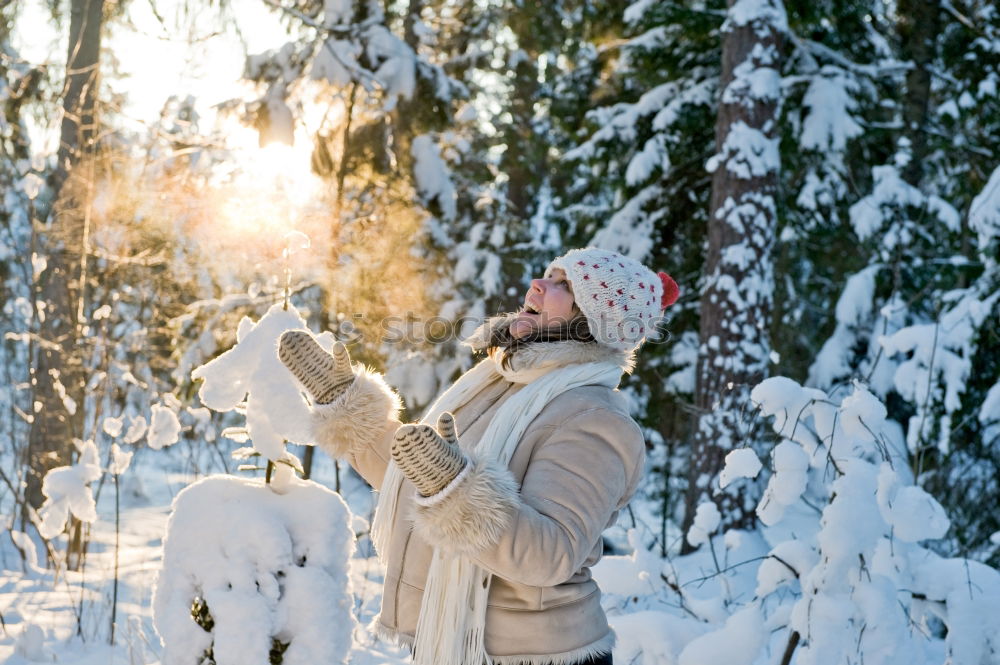 Similar – portrait Young pretty woman enjoying and playing with snow in winter