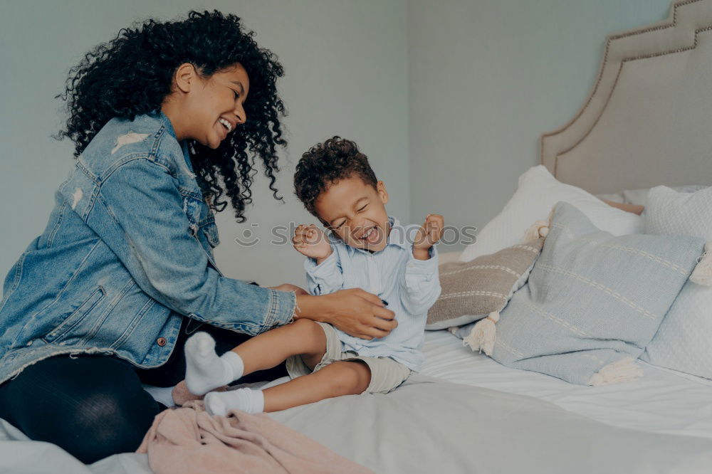 Similar – Happy mom and daughter using digital tablet together