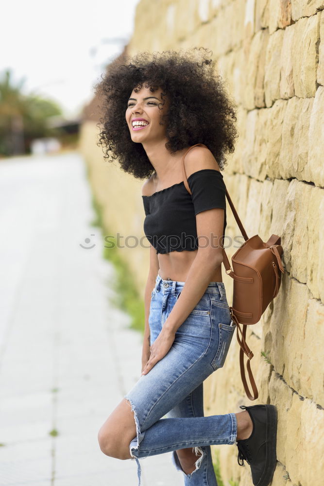 Similar – Young black woman with afro hairstyle smiling in urban park